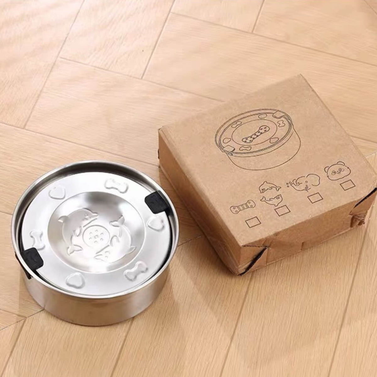 Stainless steel floating dog water bowl displayed next to its retail packaging box