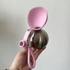 Dog Travel Water Bottle held in hand showing compact size