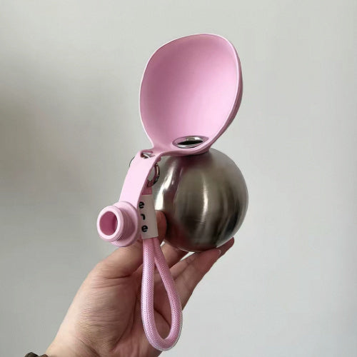 Dog Travel Water Bottle held in hand showing compact size