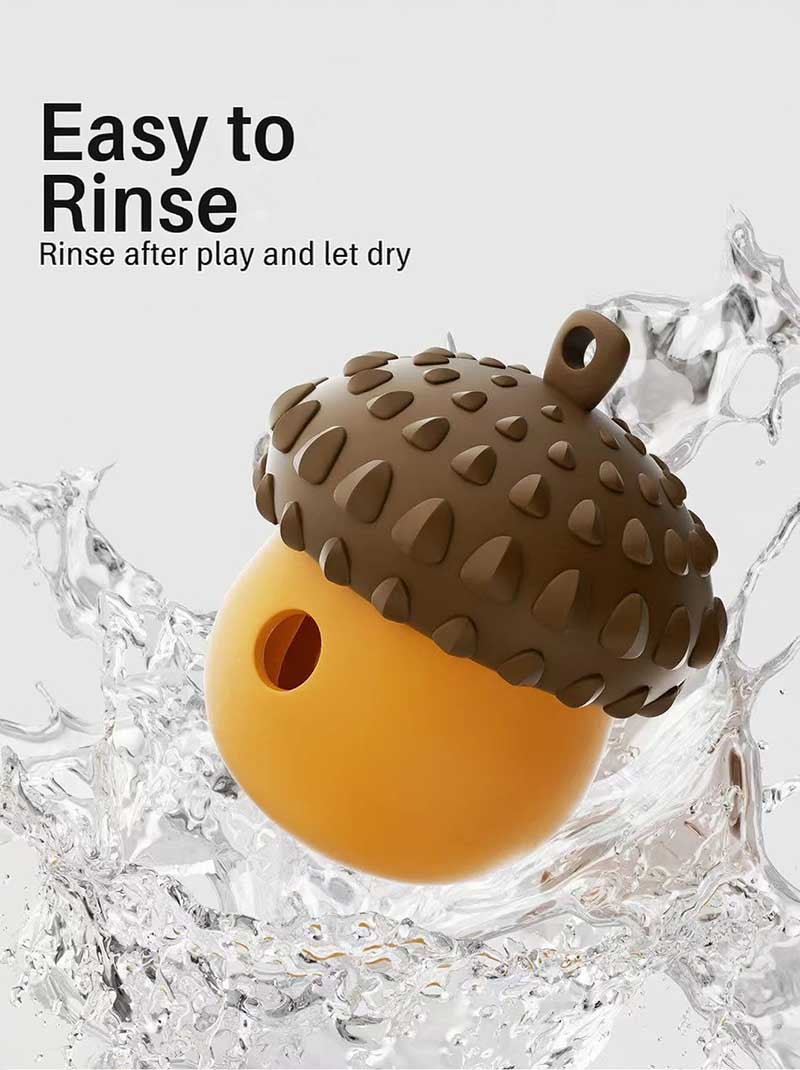 Orange acorn treat toy splashed with water, illustrating rinse-and-dry care