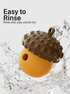 Orange acorn treat toy splashed with water, illustrating rinse-and-dry care
