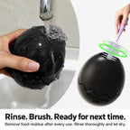 Rinsing the egg-shaped toy and brushing food residue from inside